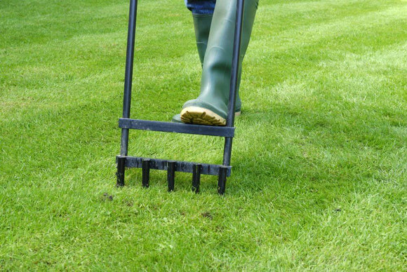 Homeowner aerating their lawn in East Brookfield, MA