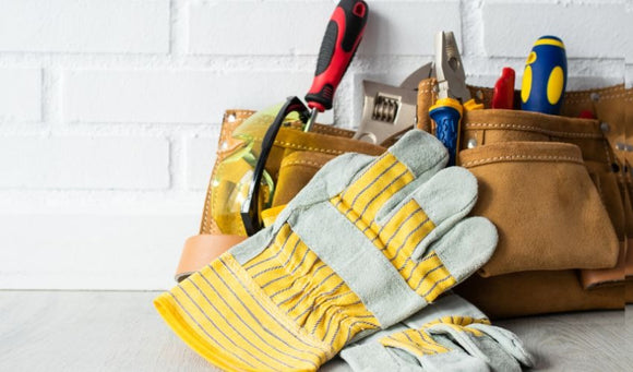 Tools and gloves arranged on a wooden table in East Brookfield, MA
