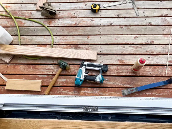 Tools lying on outdoor home deck in East Brookfield, MA