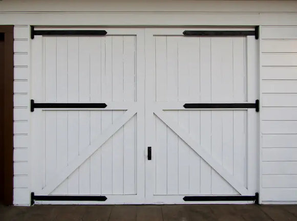 White wooden barn doors with black hinges installed in East Brookfield, MA